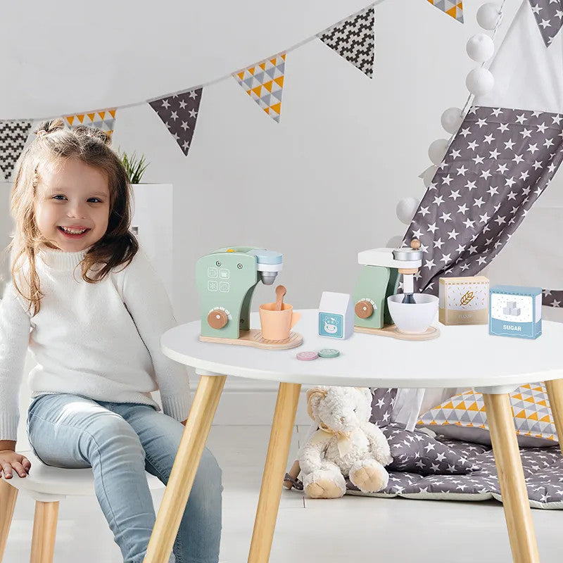 Girl sitting at the table with a wooden coffee maker and wooden kitchen mixer in a fun and decorated environment