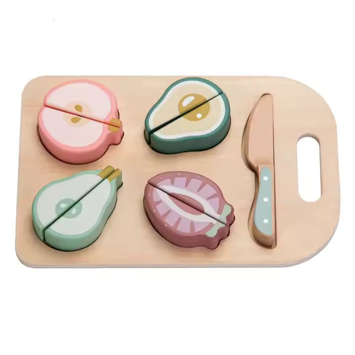 A wooden cutting board with colorful, realistic-looking fruit pieces arranged on top of it, and a wooden knife beside them.