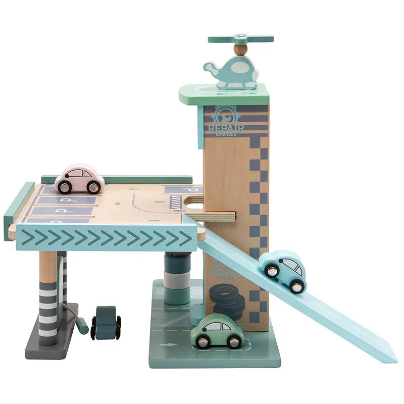 A wooden playset featuring a parking garage with elevators and a ramp, gas station with vehicles, and a repair shop.