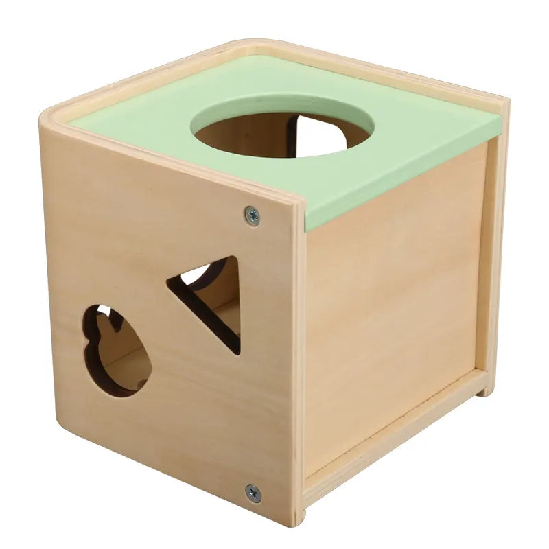 A wooden shape sorting cube with various holes for shapes, and colorful numbered shapes.
